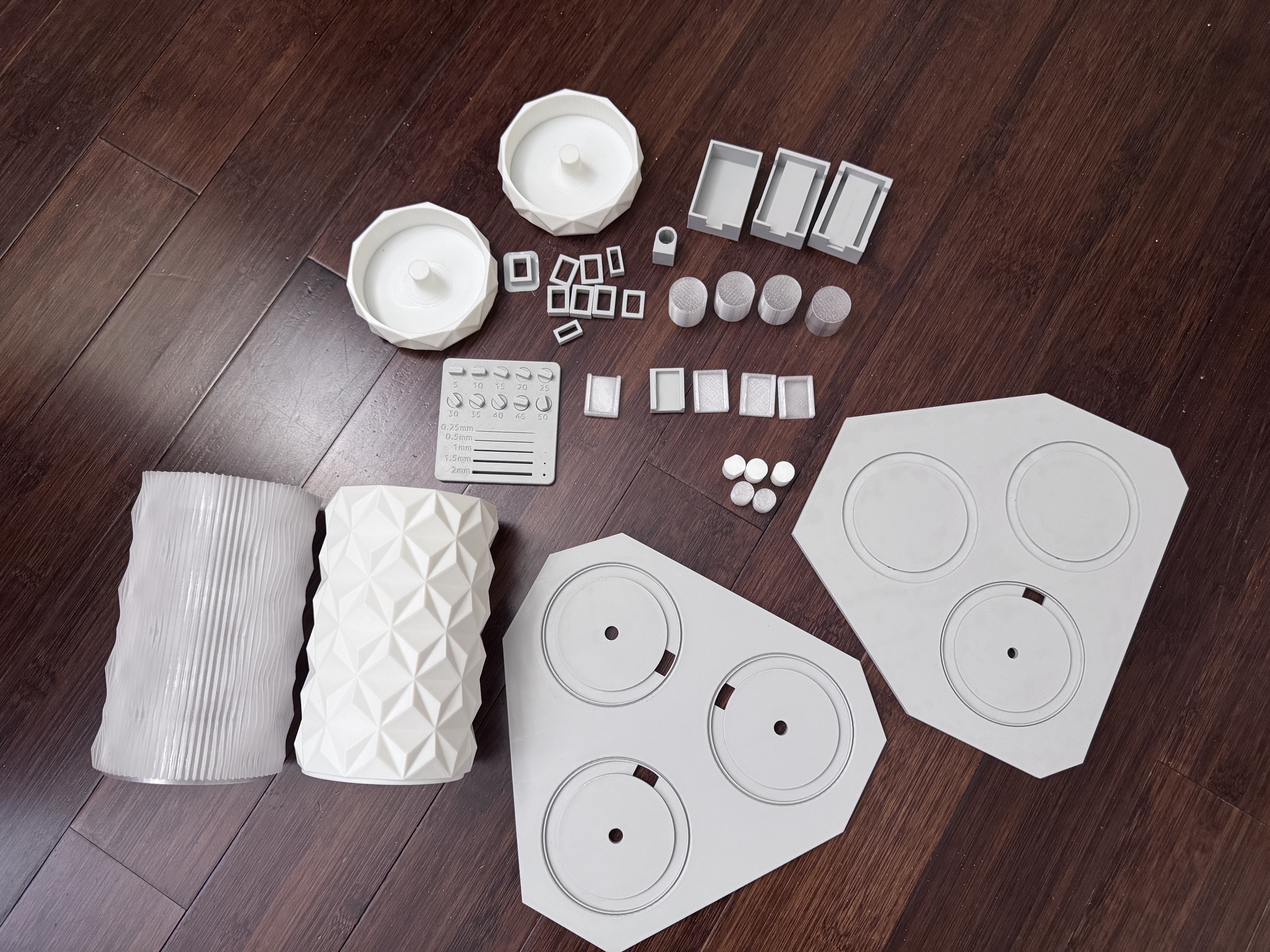 Photo of most of the 3D printed test parts that I made for testing part tolerances and dimensional accuracy for the 'perfect' fit.